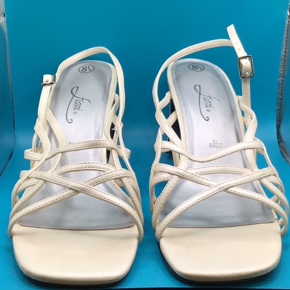 Fioni, crème pearly color strappy heels.